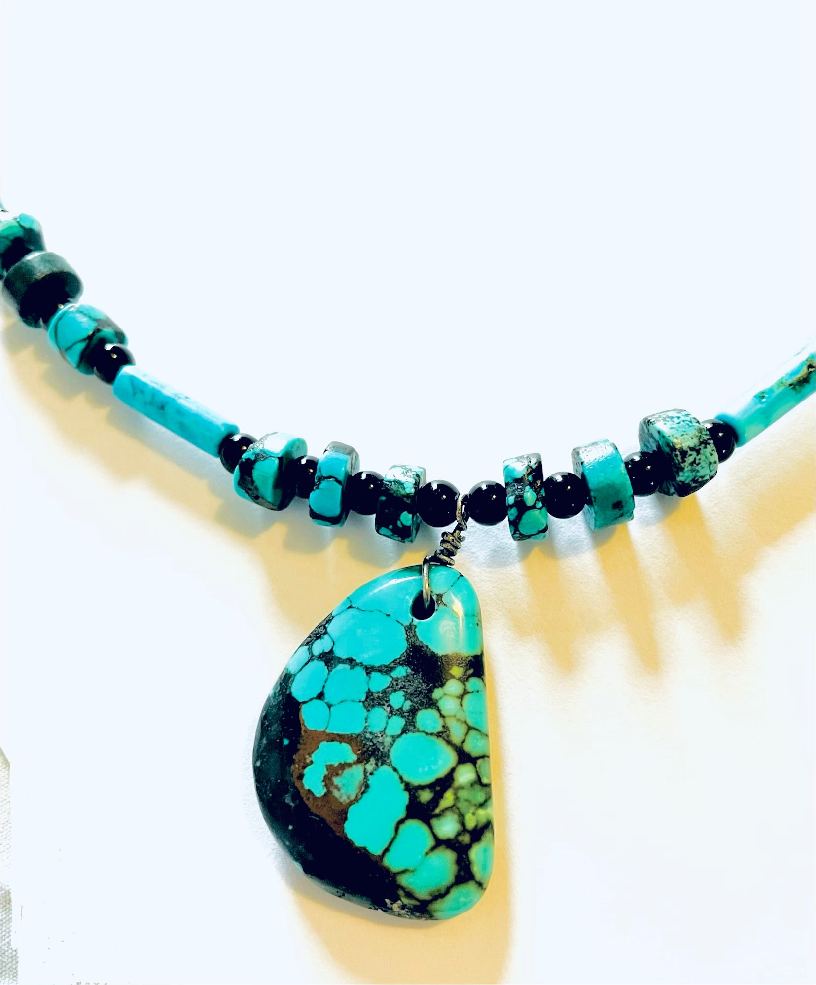 Turquoise pendant with rough cut turquoise accent beads and black Onyx spacers